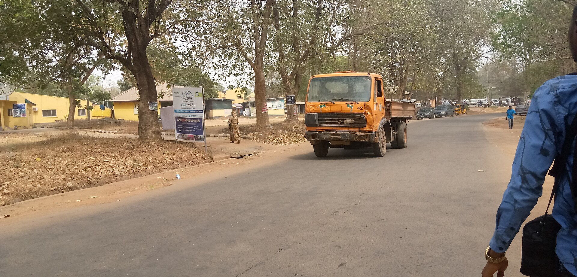 Loaded dump truck hauling aggregate material along a road to a delivery site